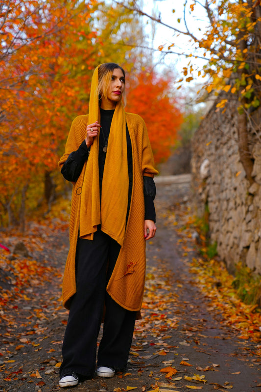 a woman standing on a path in the fall