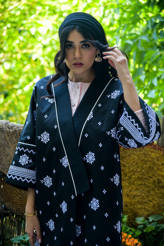 a woman in a black and white kimono