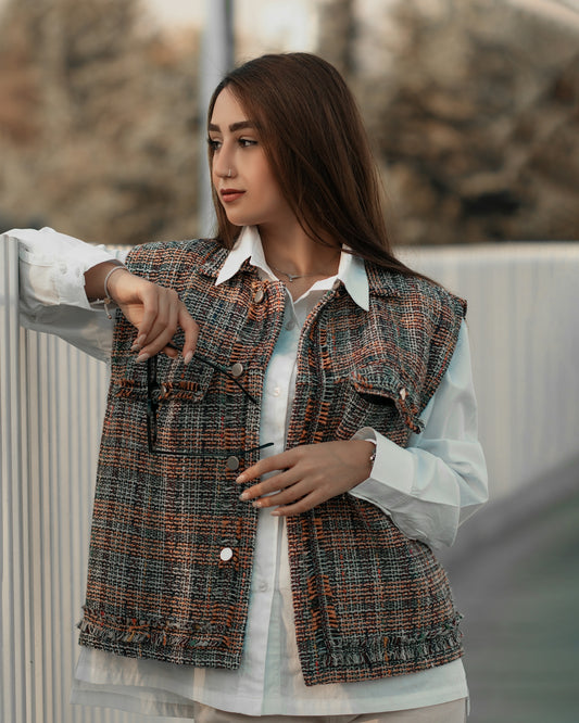 a woman pointing at something while standing next to a fence