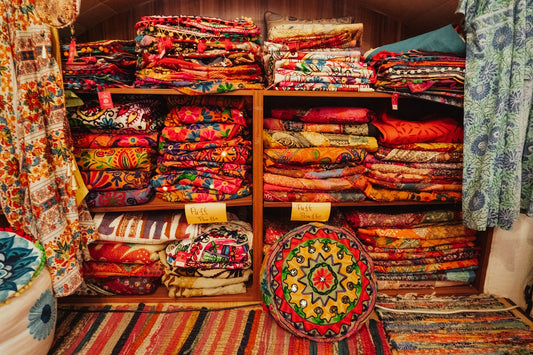 A room filled with lots of colorful fabrics and rugs