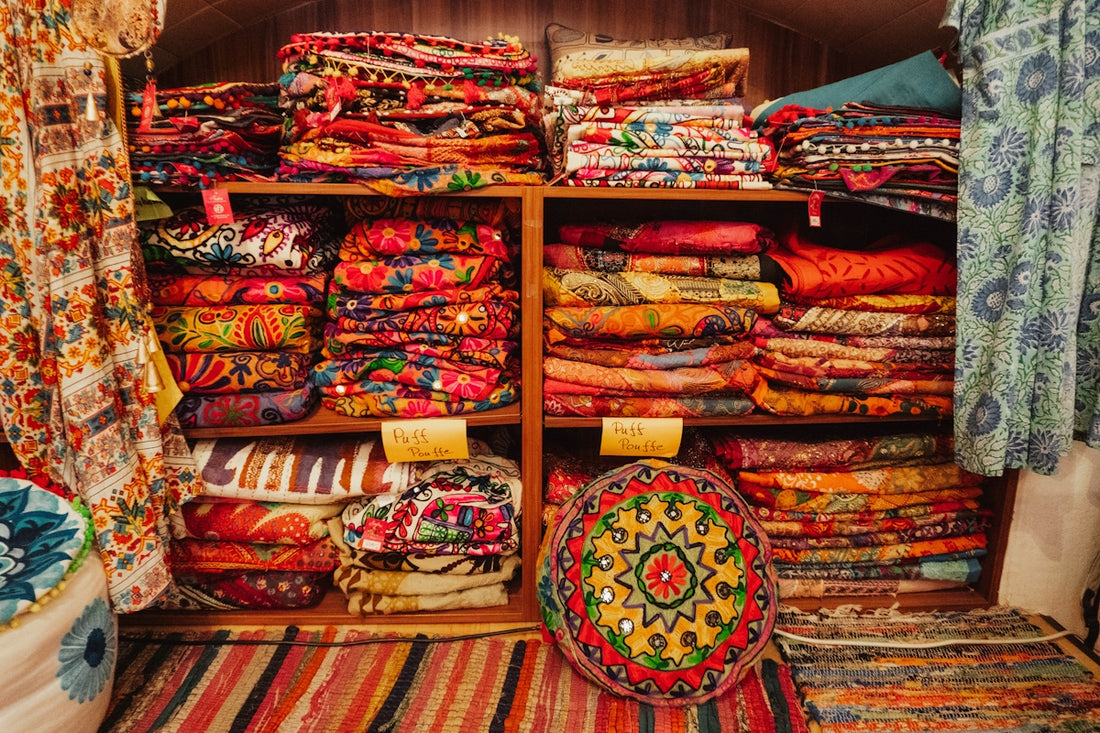A room filled with lots of colorful fabrics and rugs