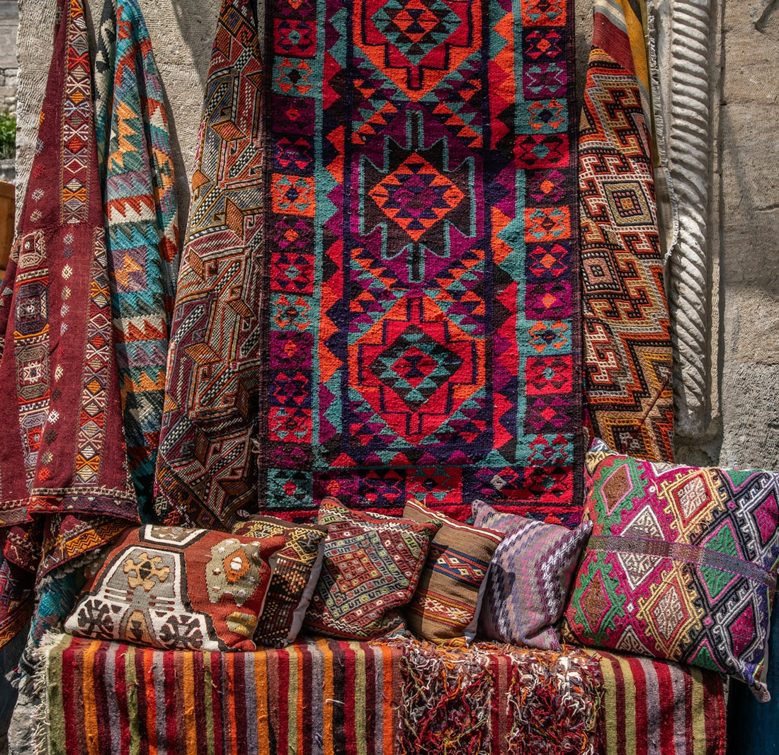 Beautiful, colorful rugs and pillows for sale.