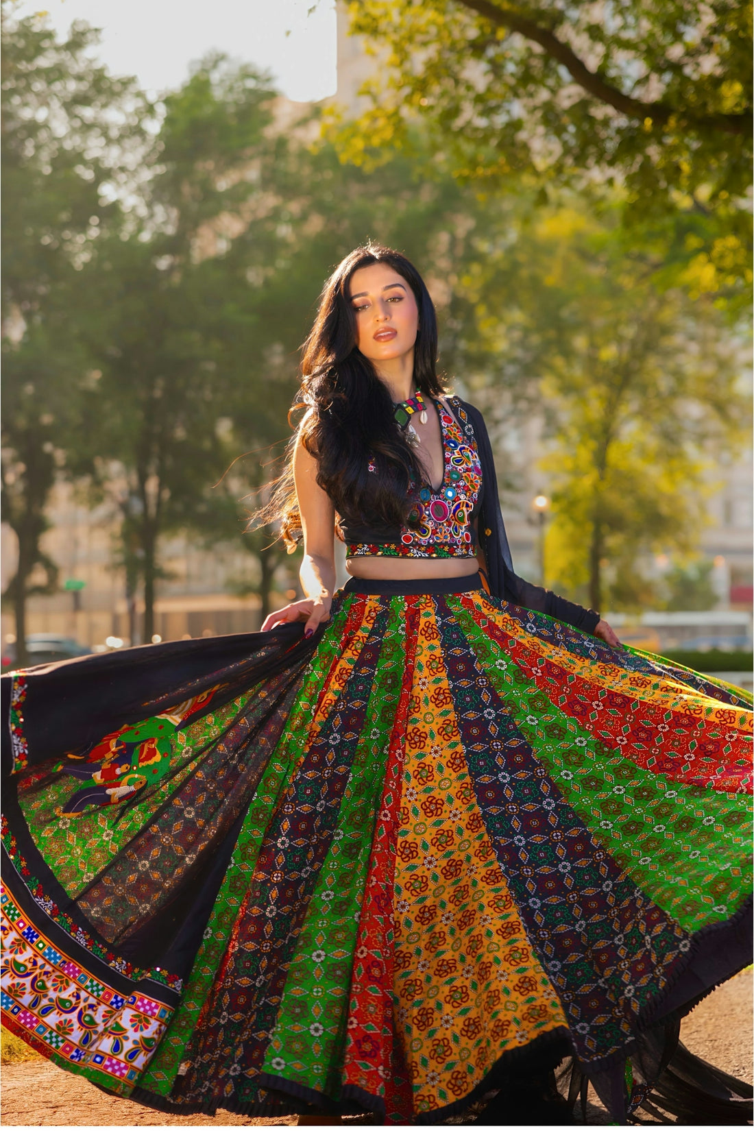 Woman twirling in colorful traditional indian attire.