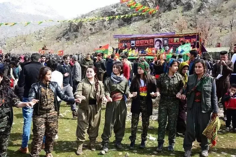 People wearing the YPG scarf